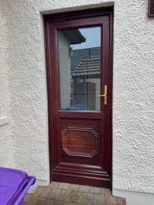 Old sun damaged rosewood upvc back door