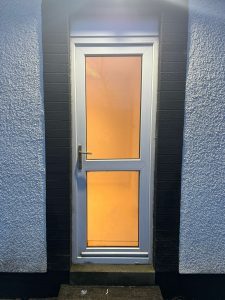 old upvc back door in white