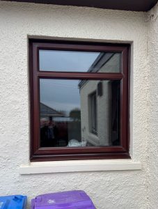 old sun damaged rosewood upvc casemwnt window